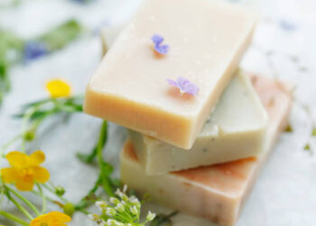 Handmade natural soaps with plants and flowers, closeup