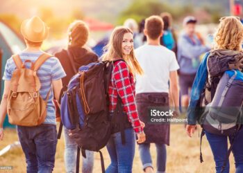Group of beautiful teens arriving at summer festival